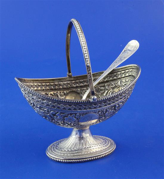 A Victorian silver boat shaped pedestal sugar basket and matching sifter spoon, 5 oz.